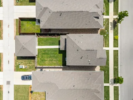 an aerial view of a house with a yard