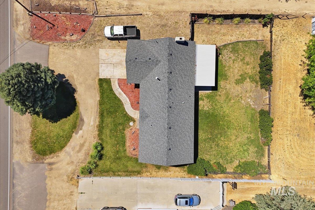1311 North Middleton Road Nampa, ID 83651 - Photo 6 of 49 Property featuring a composite shingle roof, paved driveway, and established landscaping