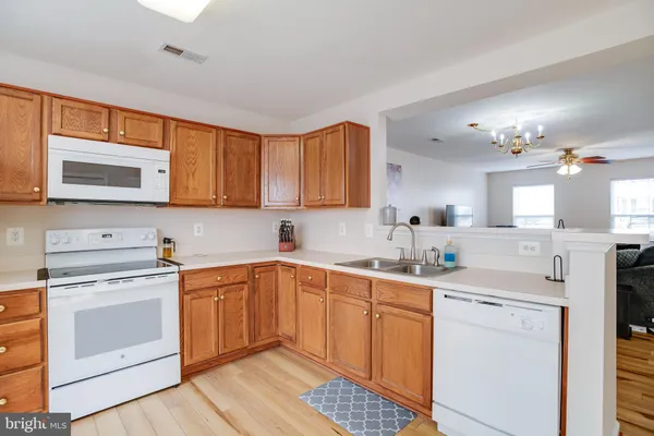 a kitchen with a sink stove and microwave