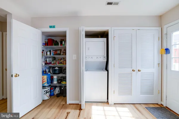 a view of empty room with closet and wooden floor