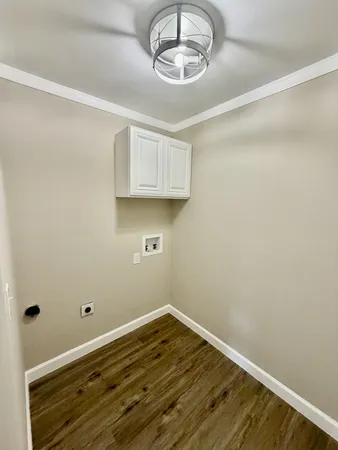 a view of room with wooden floor and cabinet