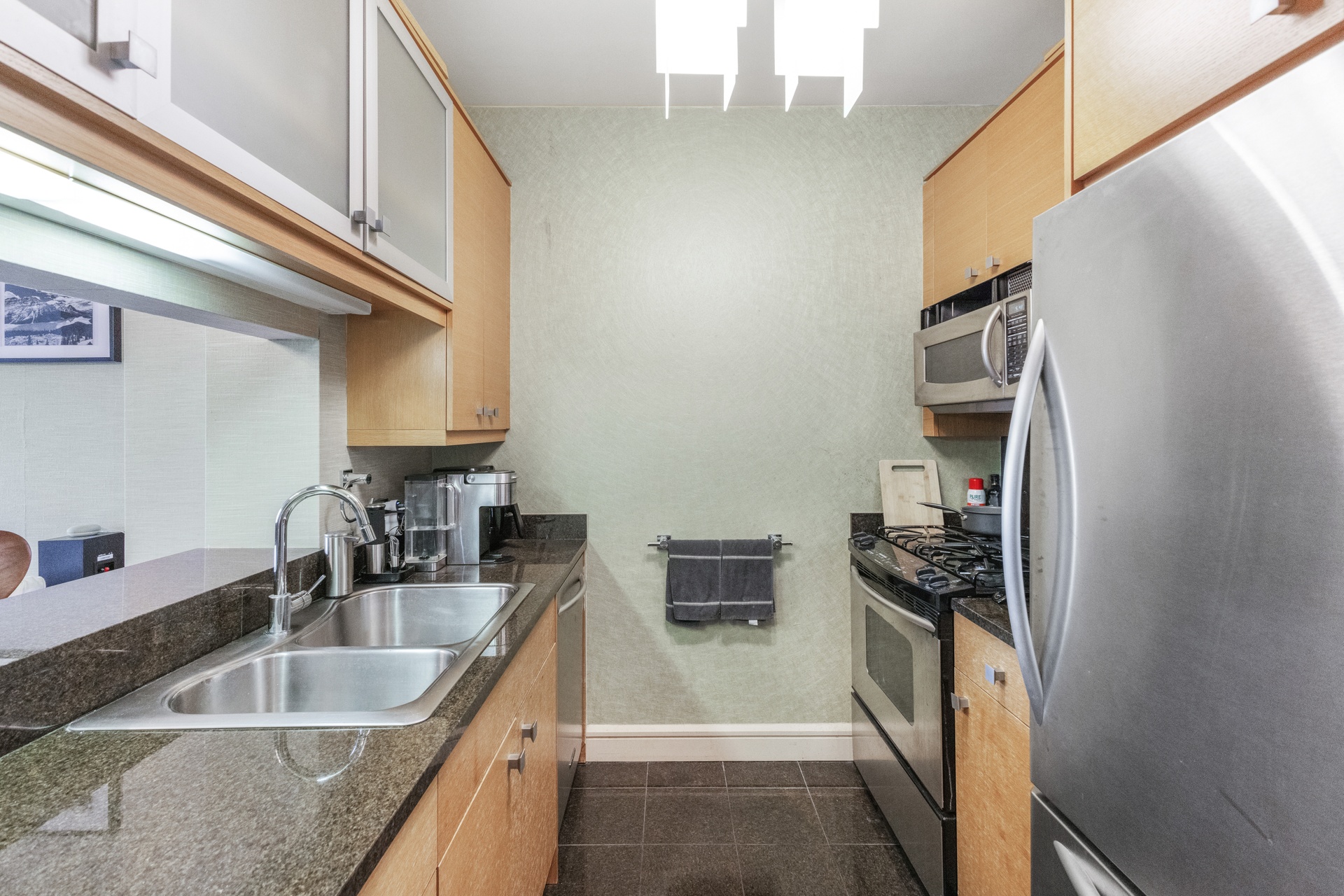120 Riverside Boulevard, Unit 14C Manhattan, NY 10069 - Photo 10 of 11 a kitchen with a sink stove and refrigerator