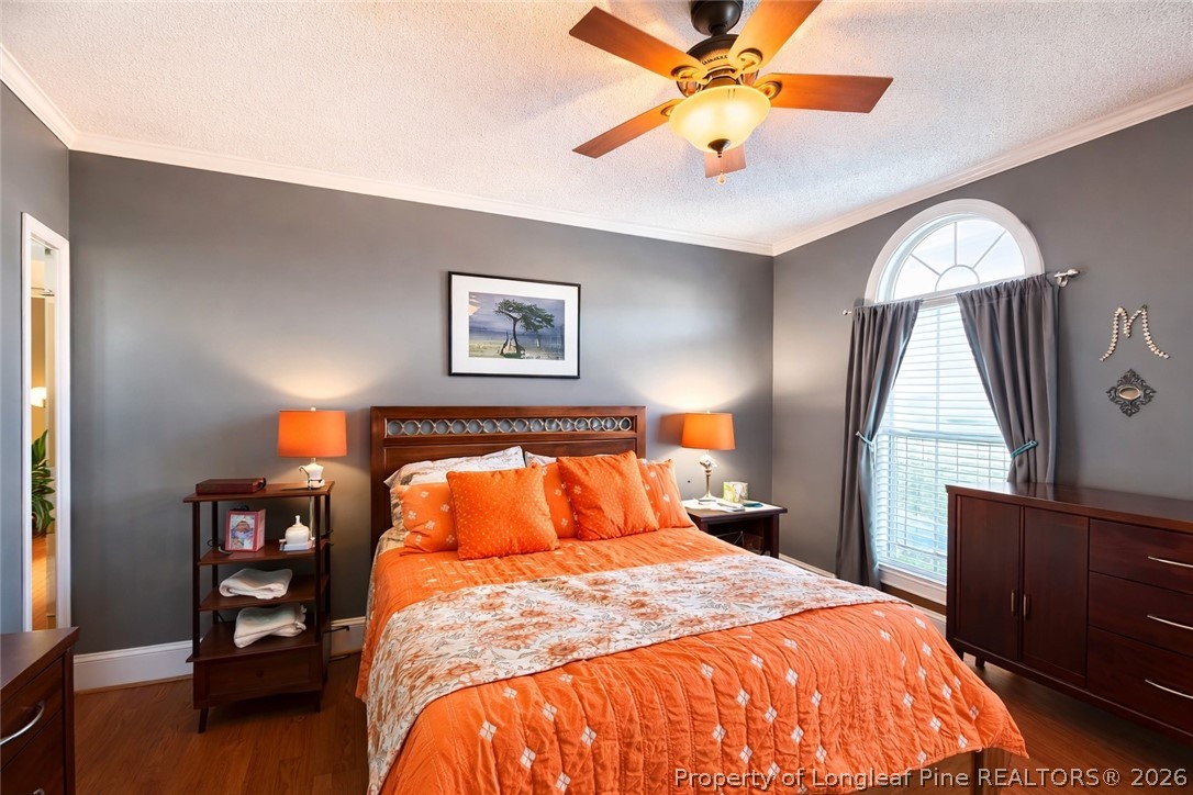 2001 Old Lumberton Road Whiteville, NC 28472 - Photo 14 of 25 a bedroom with a bed and a chandelier