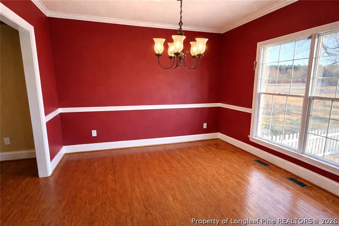 2001 Old Lumberton Road Whiteville, NC 28472 - Photo 7 of 25 a view of an empty room with wooden floor and a window