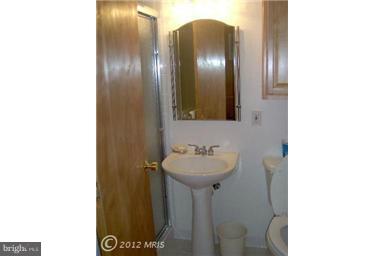 6307 Brooklyn Bridge Road Laurel, MD 20707 - Photo 2 of 17 a bathroom with a sink and a mirror