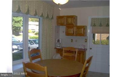 6307 Brooklyn Bridge Road Laurel, MD 20707 - Photo 15 of 17 a view of a dining room with furniture and a potted plant