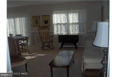 6307 Brooklyn Bridge Road Laurel, MD 20707 - Photo 16 of 17 a living room with furniture a flat screen tv and a large window