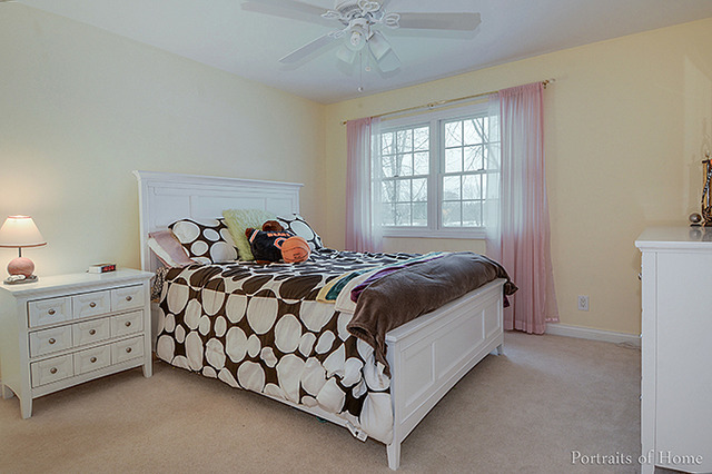 38W194 Pine Road St. Charles, IL 60175 - Photo 16 of 24 a bedroom with a bed and a chandelier