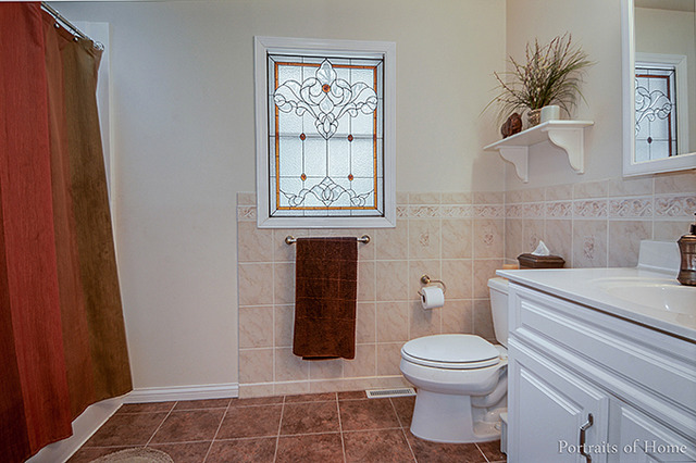 38W194 Pine Road St. Charles, IL 60175 - Photo 18 of 24 a bathroom with a toilet a sink and a window