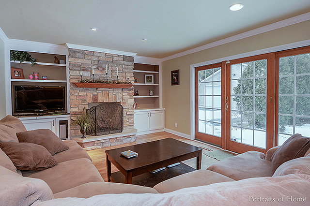 38W194 Pine Road St. Charles, IL 60175 - Photo 7 of 24 a living room with furniture a flat screen tv and a fireplace