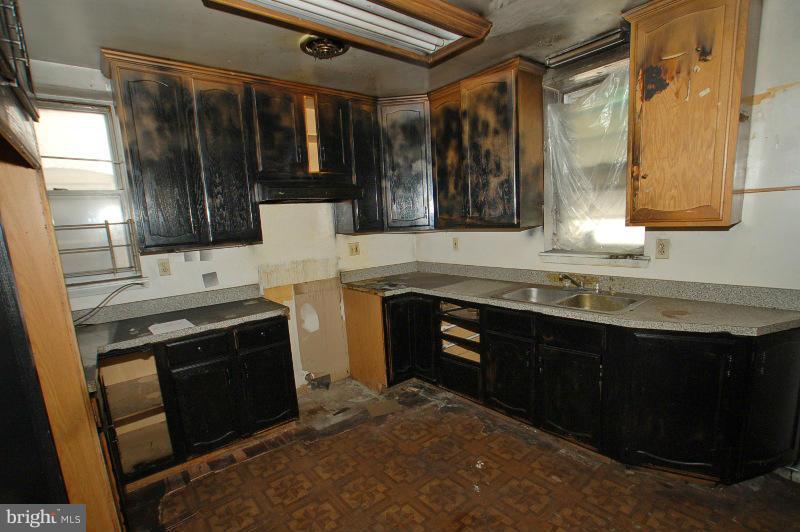3735 Reisterstown Road Baltimore, MD 21215 - Photo 22 of 29 a kitchen with stainless steel appliances granite countertop a stove a sink and a microwave