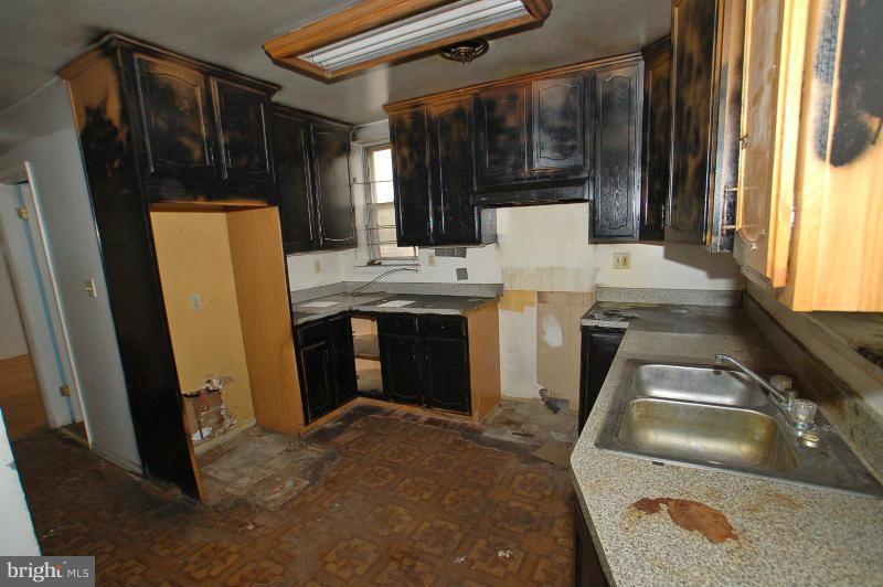 3735 Reisterstown Road Baltimore, MD 21215 - Photo 23 of 29 a kitchen with a sink and a refrigerator