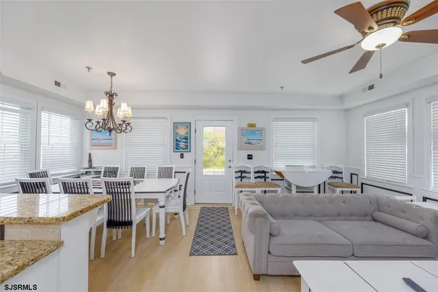 a dining room with furniture a rug and a chandelier