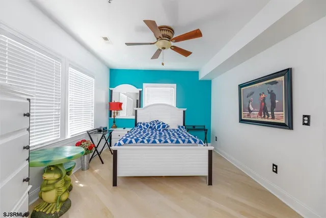 a living room with a bed and a flat screen tv