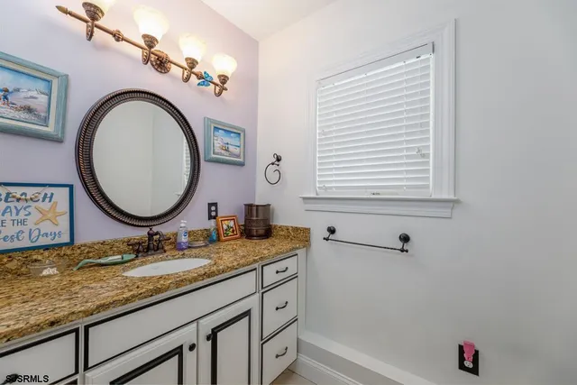a bathroom with a glass shower door and mirror