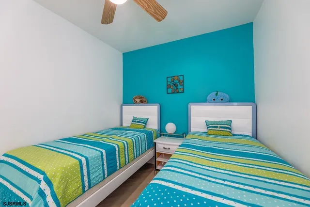 a bedroom with two beds and a table