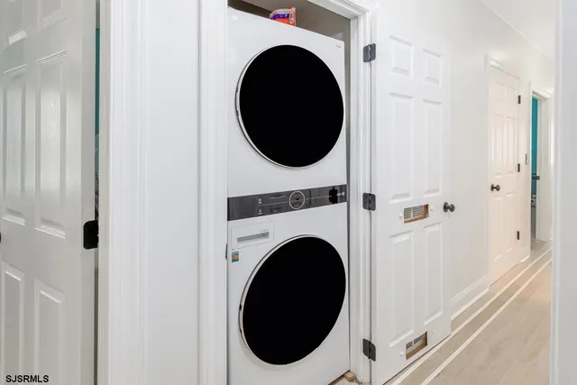 a view of a hallway with washer and dryer