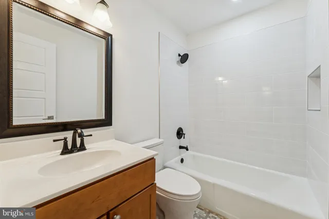 a bathroom with a sink toilet a mirror and shower