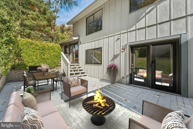 a view of a patio with couches table and chairs and potted plants