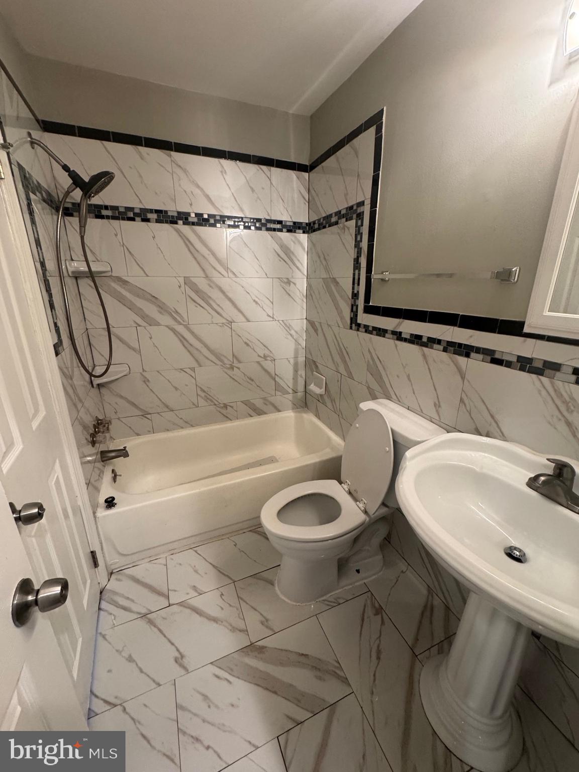 8587 Tyrolean Way Springfield, VA 22153 - Photo 11 of 19 a bathroom with a sink a toilet and shower