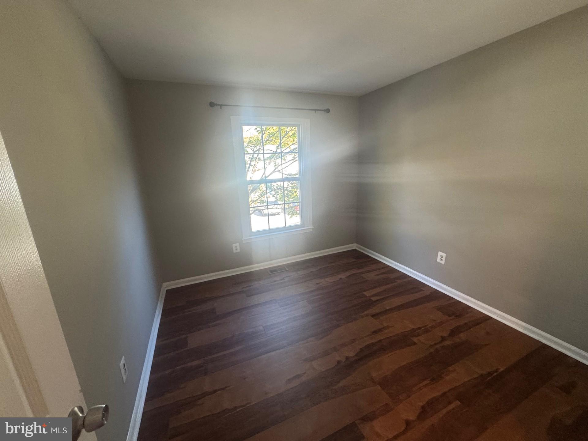 8587 Tyrolean Way Springfield, VA 22153 - Photo 13 of 19 an empty room with wooden floor and windows