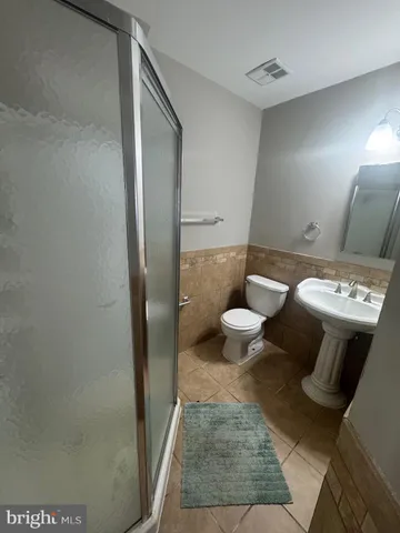 a bathroom with a toilet and a mirror