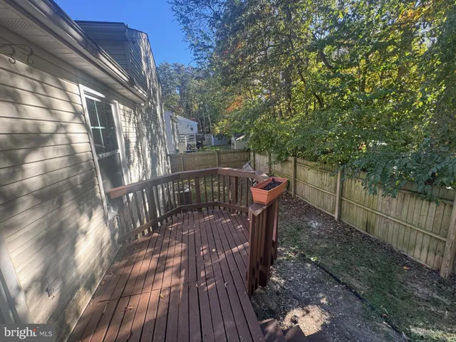 a view of balcony with wooden floor and fence