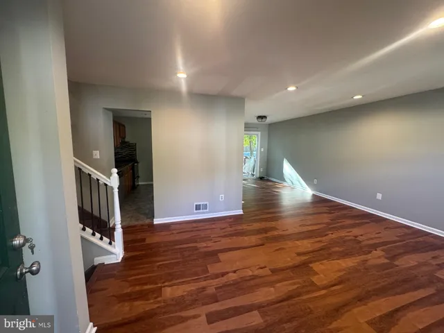 wooden floor in an empty room with a fireplace