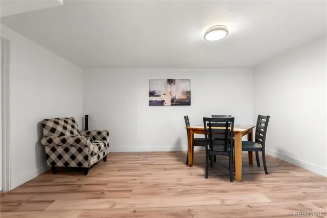 a view of a workspace with furniture and wooden floor
