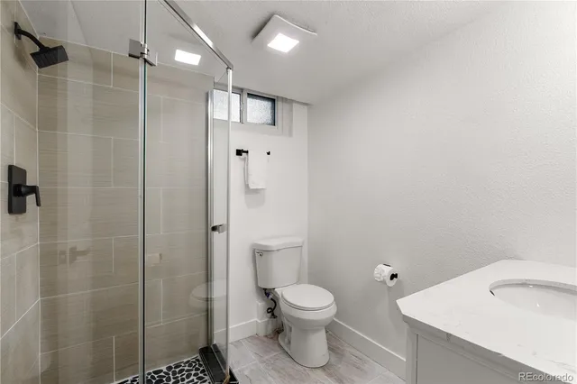 a bathroom with a toilet sink and shower