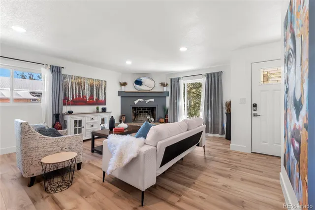 a living room with furniture and a fireplace