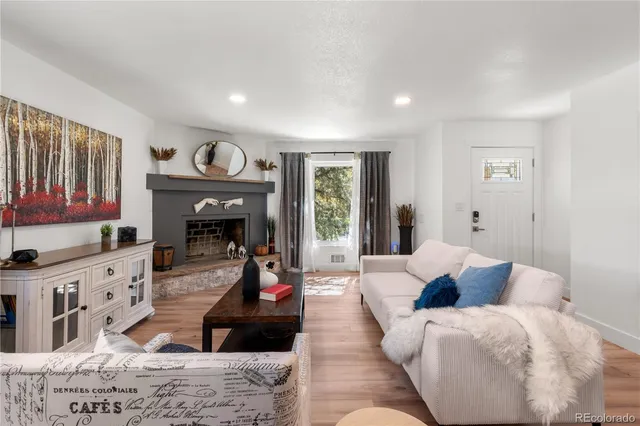 a living room with furniture and a fireplace