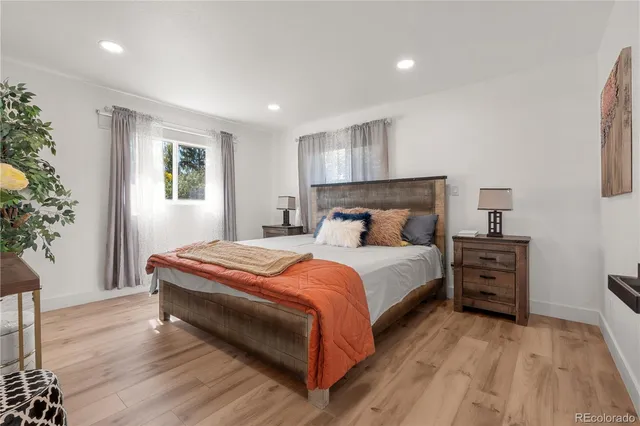 a bedroom with a bed and a potted plant