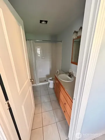 a bathroom with a sink a toilet a tub and a mirror