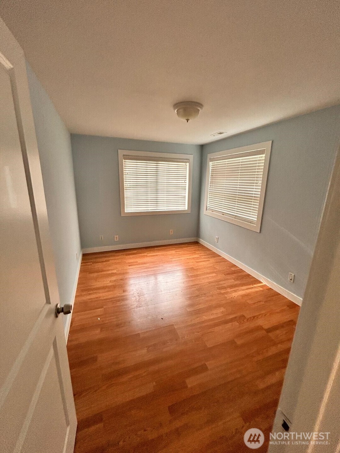 3232 Russet Road Brier, WA 98036 - Photo 10 of 11 a view of empty room with wooden floor and fan