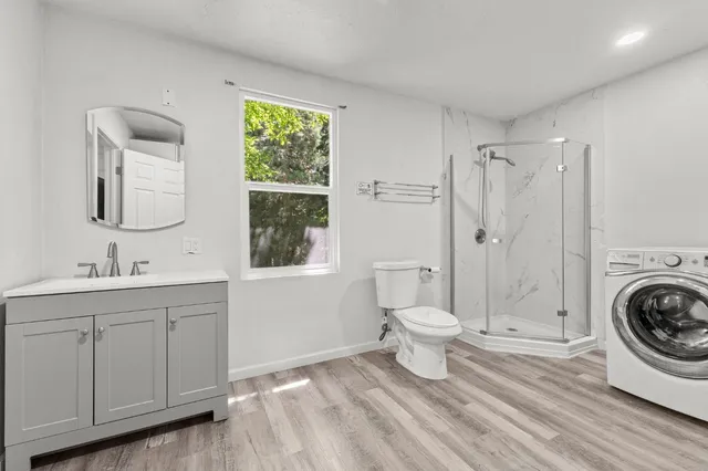 a bathroom with a toilet a sink and a window
