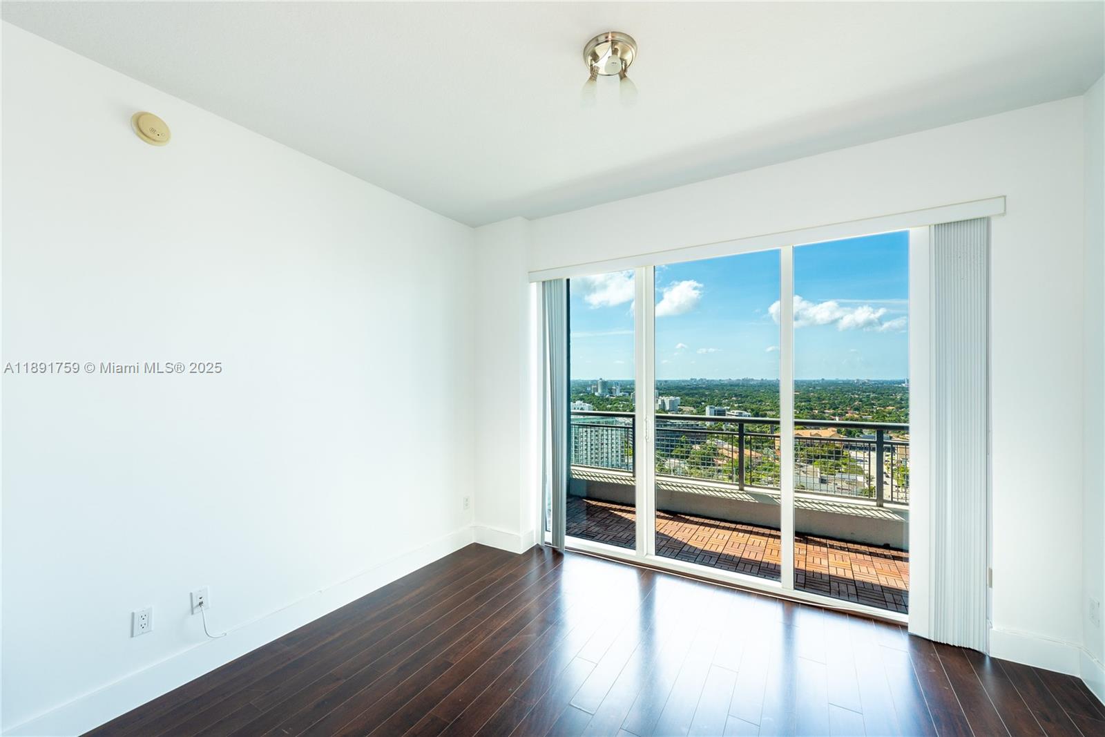 60 Southwest 13th Street, Unit 2017 Miami, FL 33130 - Photo 1 of 23 an empty room with wooden floor and windows