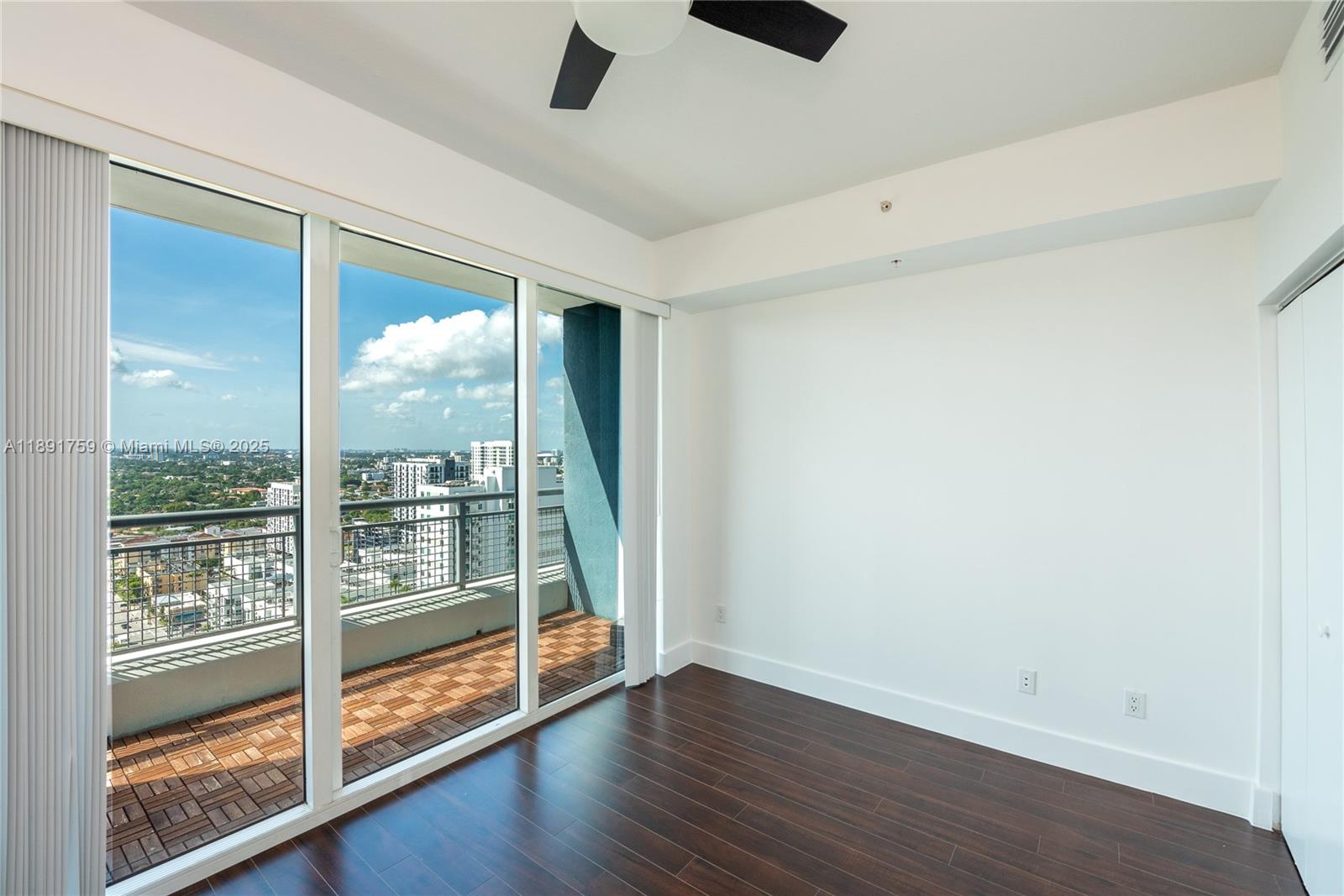 60 Southwest 13th Street, Unit 2017 Miami, FL 33130 - Photo 13 of 23 an empty room with wooden floor and windows