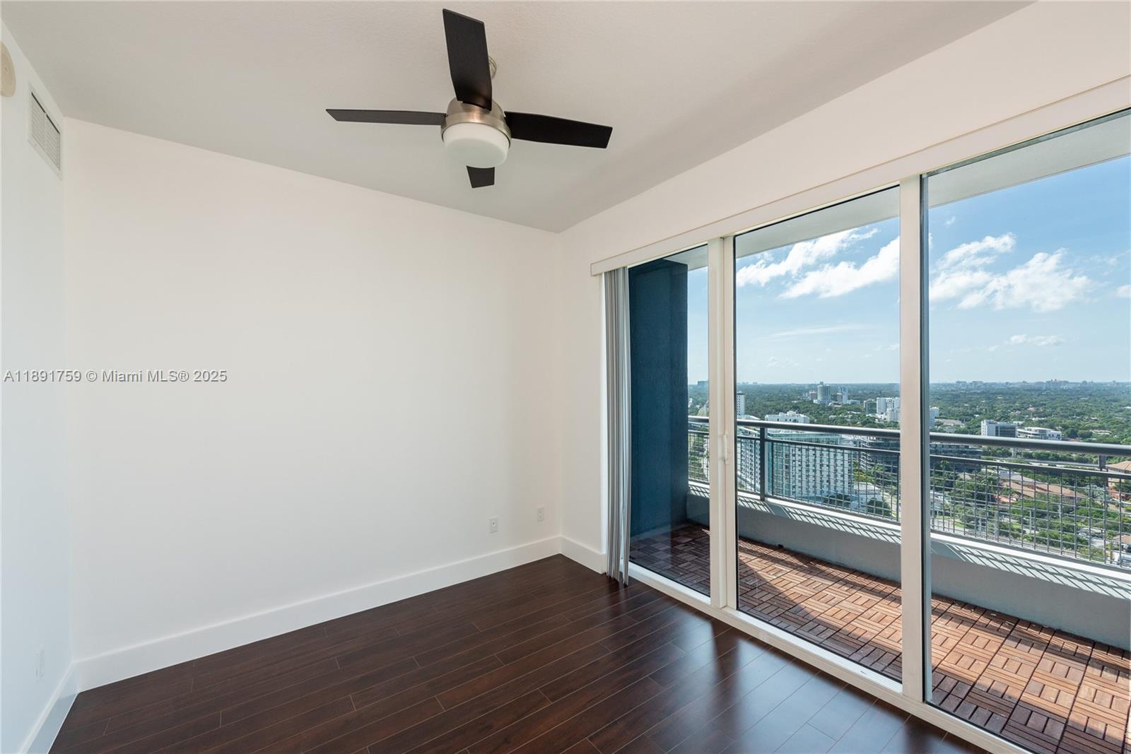 60 Southwest 13th Street, Unit 2017 Miami, FL 33130 - Photo 14 of 23 an empty room with wooden floor and windows