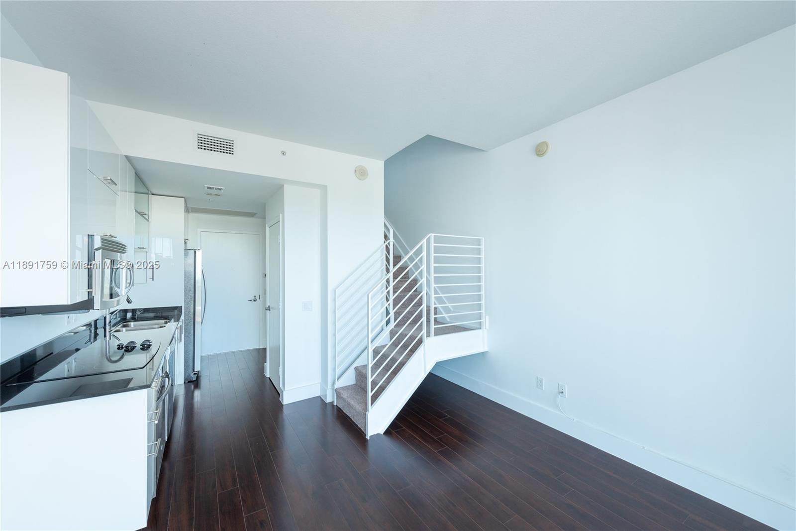 60 Southwest 13th Street, Unit 2017 Miami, FL 33130 - Photo 2 of 23 a view of a hallway with wooden floor