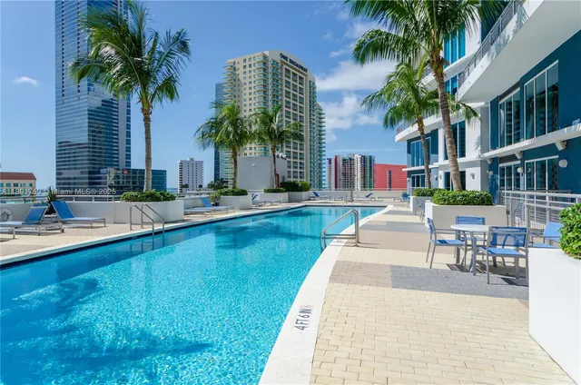a swimming pool with outdoor seating and yard