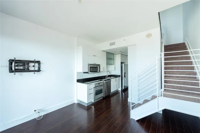 a kitchen with granite countertop a stove and a refrigerator