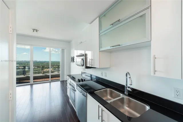 a kitchen with a sink and a window