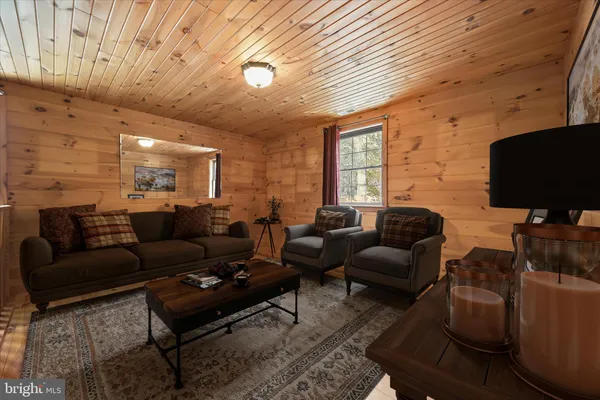 a spacious bedroom with a bed a couch and potted plant