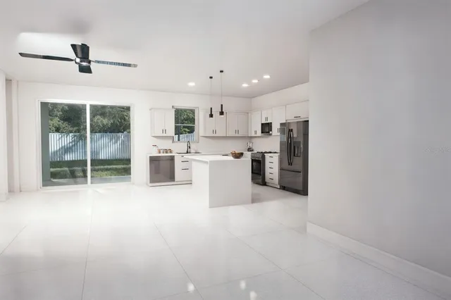 a kitchen with stainless steel appliances granite countertop a refrigerator sink and cabinets