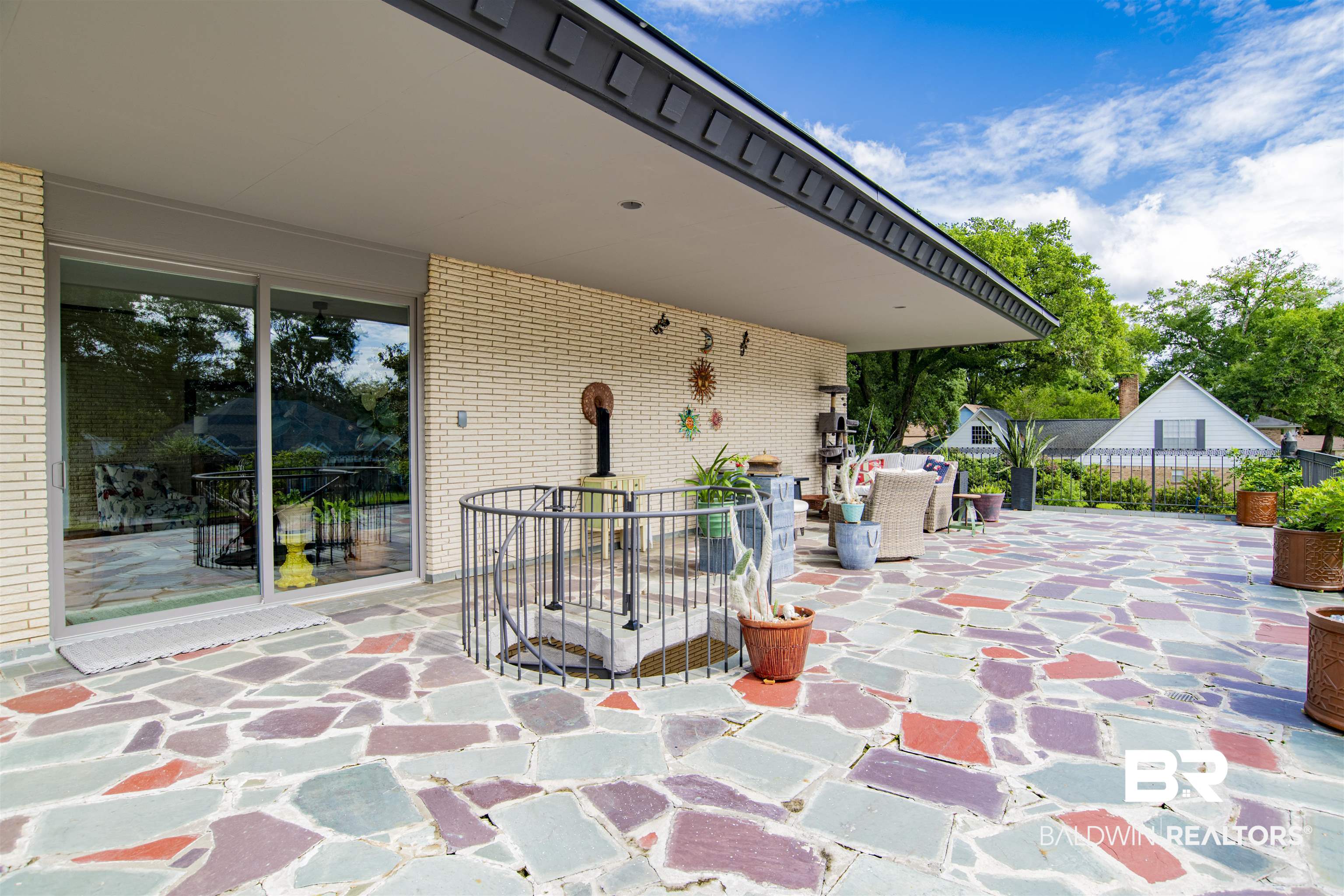 809 Bernard Circle Mobile, AL 36693 - Photo 55 of 75 Expansive outdoor patio featuring multi-color flagstone paving and a built-in spiral staircase with metal railing