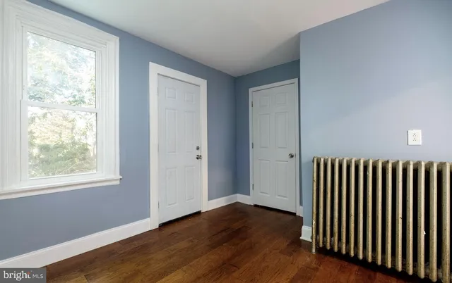 a view of wooden floor and windows in a room