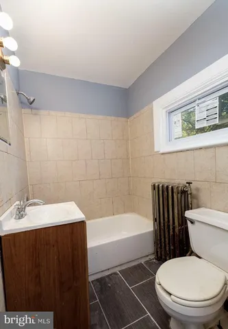 a bathroom with a sink a toilet and bathtub