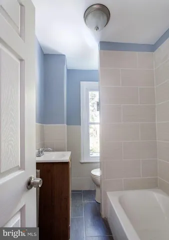 a bathroom with a bathtub sink and toilet