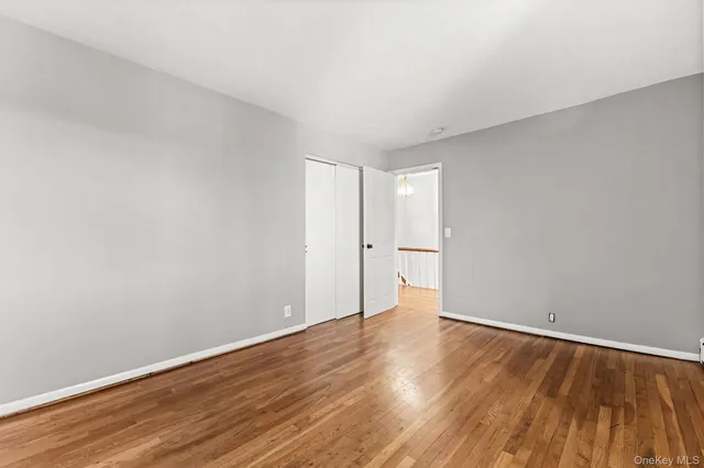 a view of wooden floor and windows in a room
